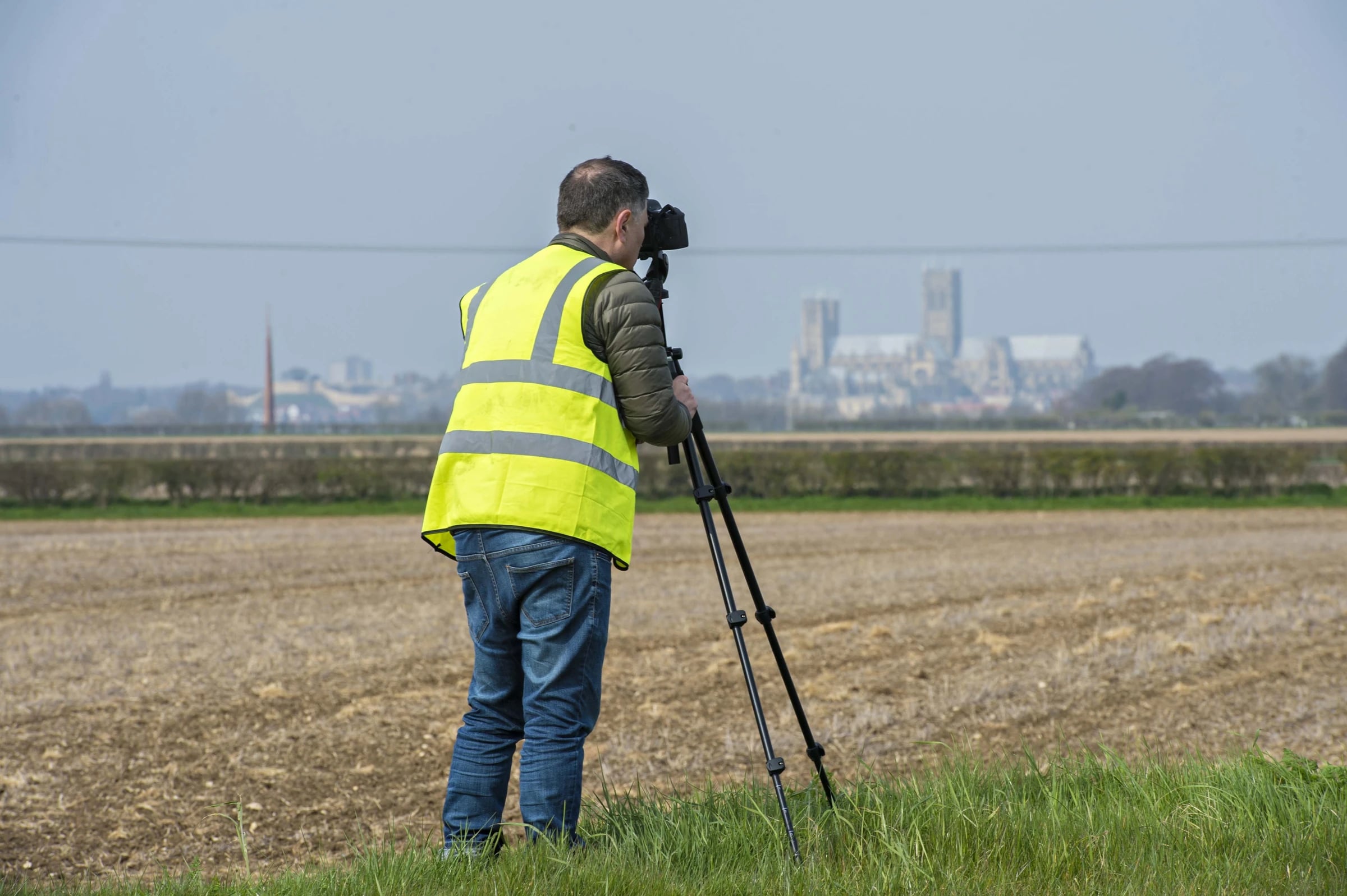 Ian using a tripod-mounted camera during a landscape site assessment