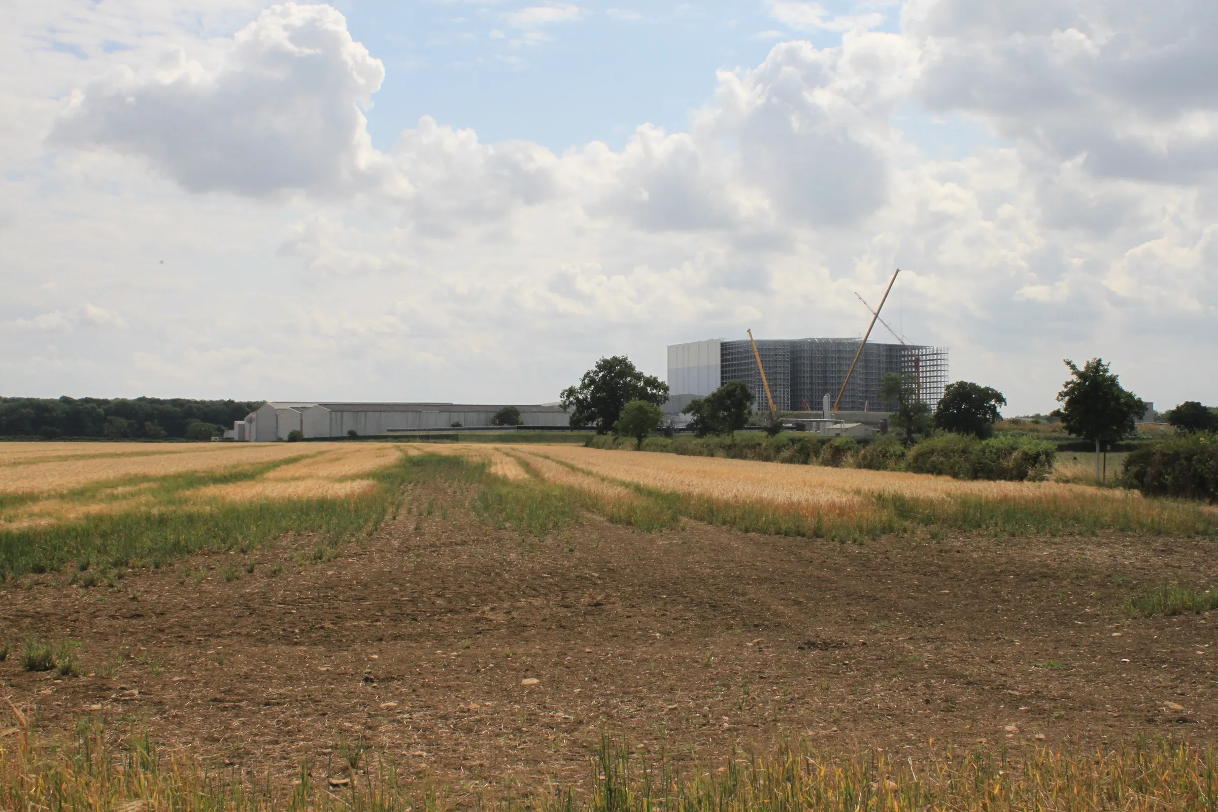Industrial development under construction within an agricultural landscape
