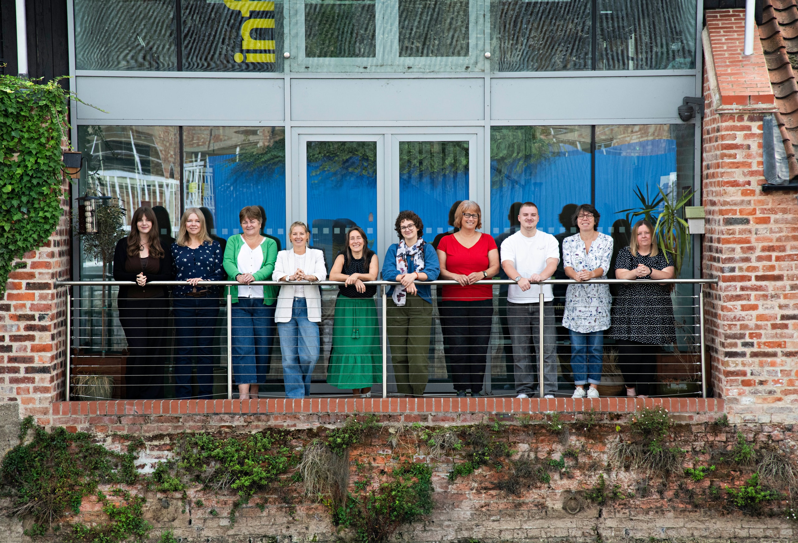 The Influence team together on the balcony of the Newark studio, September 2026