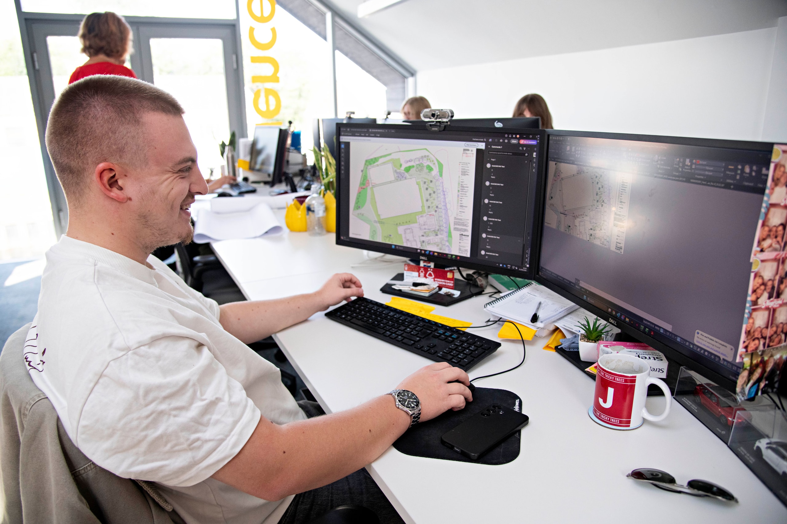 An Influence colleague working on landscape plans at a dual-screen workstation